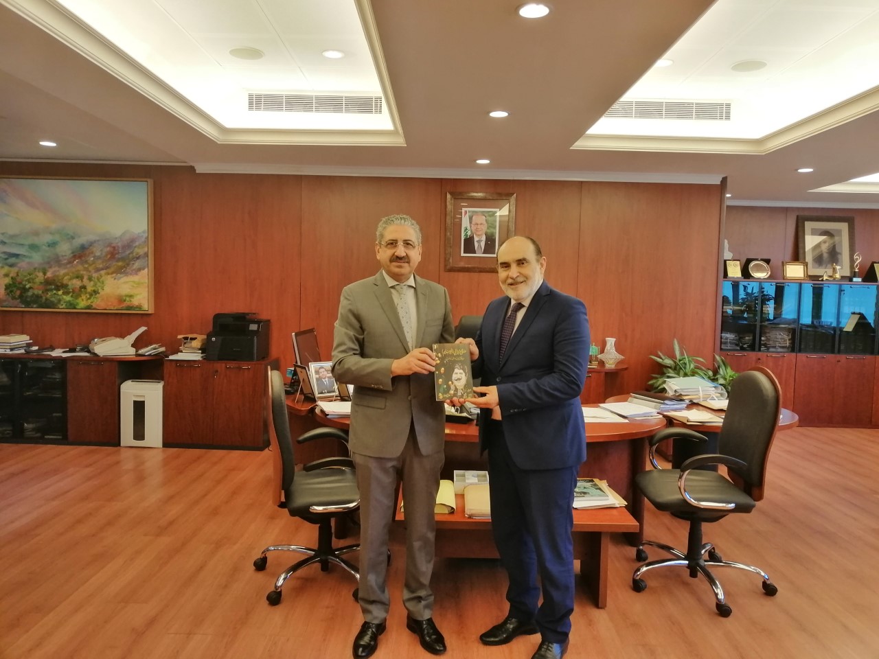 Mr. Jean Kassis hands over a copy of his book “Salah Tizani (Abu Salim) – Dell’arte Lebanon” to President Ayoub