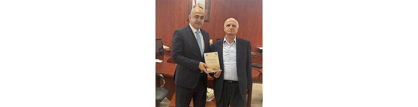 President Badran receives a copy of Dr. Najib Issa’s new book